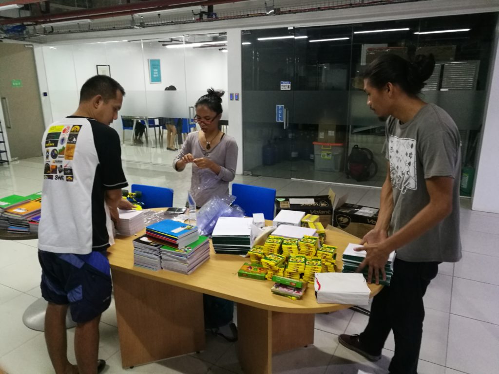 employees in photoup packaging school supplies for bayobay elementary school